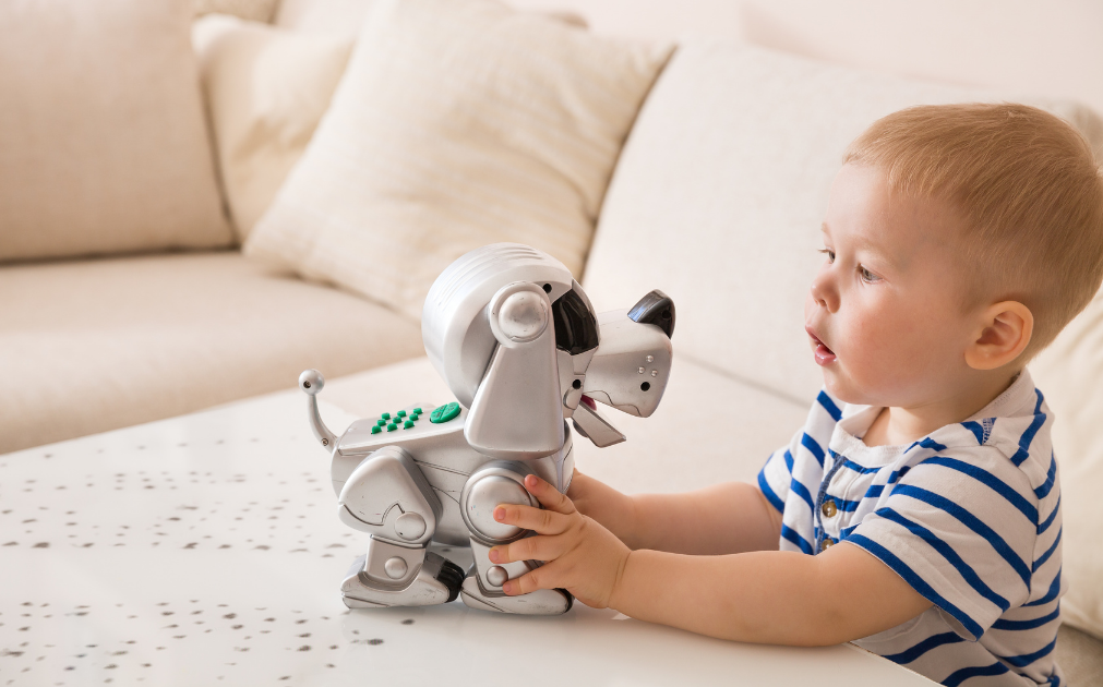 A a photo of a young boy talking to his toy dog.
