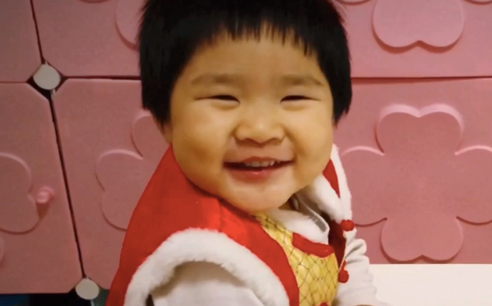 A photo of a young boy smiling.