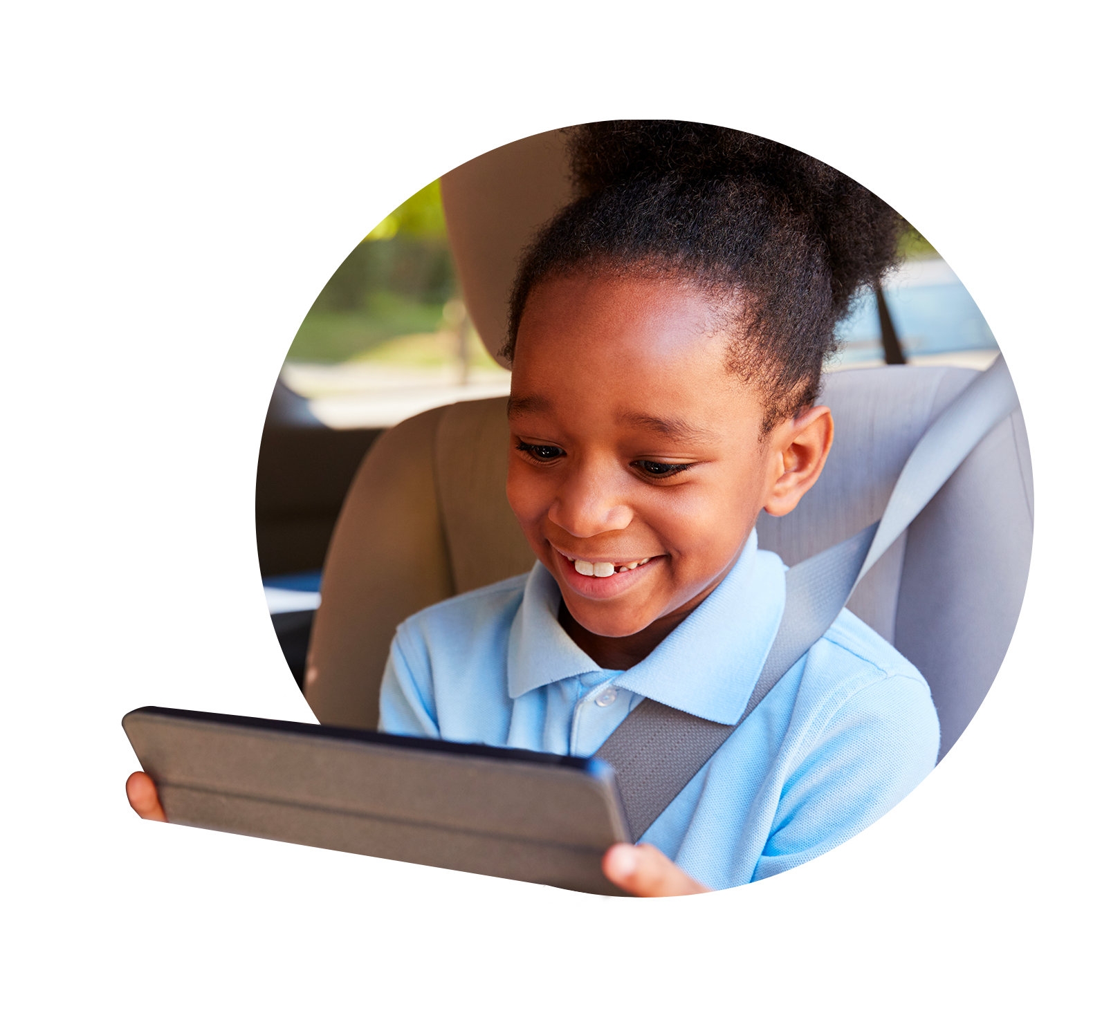 A girl sitting in a car, playing on an iPad.