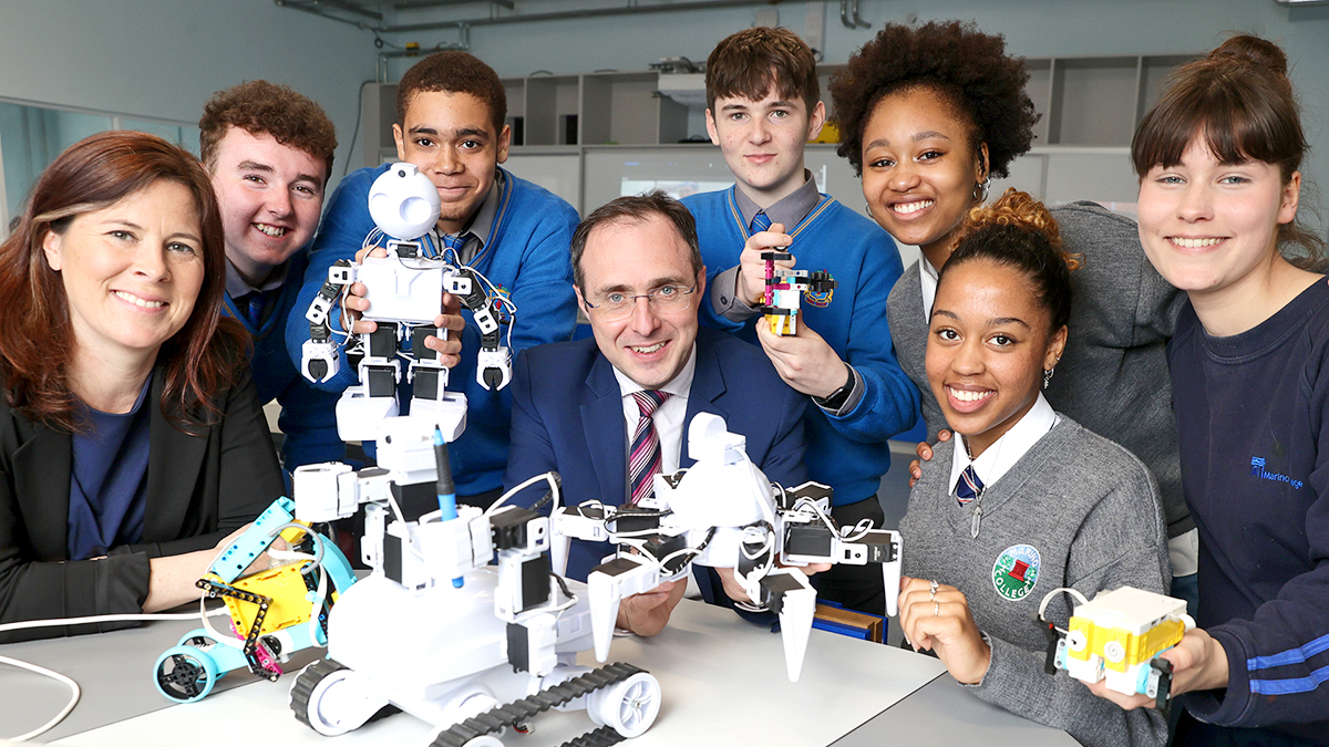 A photo of eight people, 4 women and 4 men, including Patricia Scanlon Ireland's new AI Ambassador, standing in front of an AI-powered Robot.