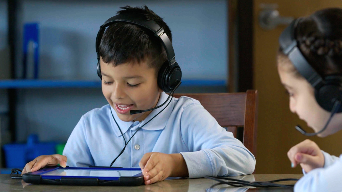 A photo of a boy sitting in a classroom completing an activity on EarlyBird's prestigious dyslexia screening platform.