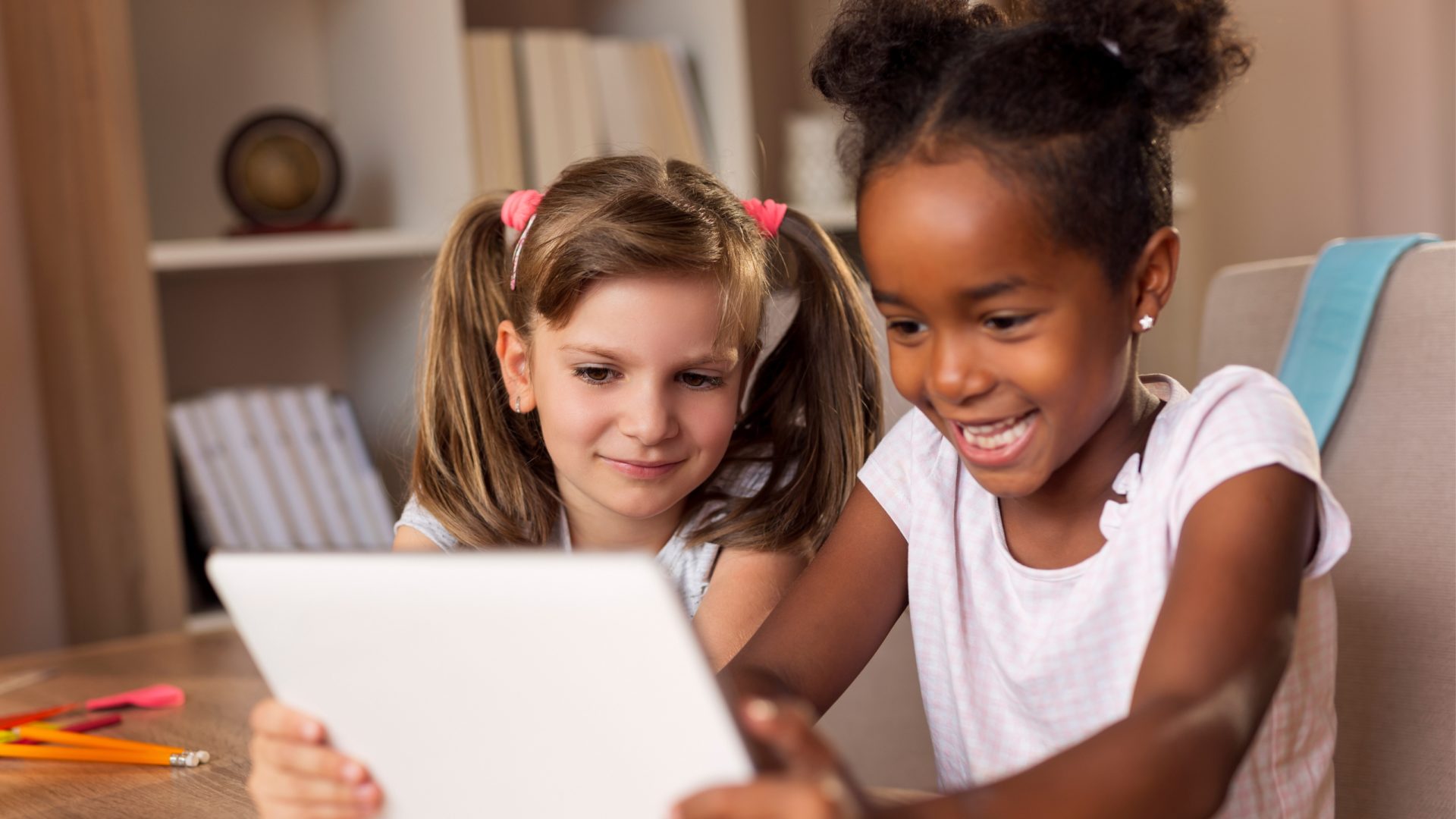 A photo of two girls using an AI-powered educational app on a tablet computer.